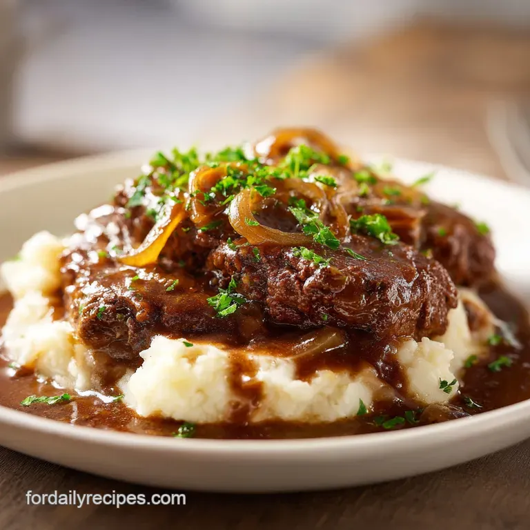 A glistening cube steak plated with creamy mashed potatoes, smothered in savory onion gravy. A sprinkle of parsley adds a ...