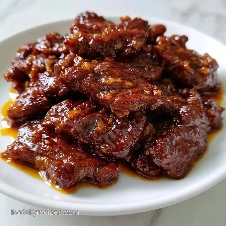 Sizzling beef strips and crisp colorful vegetables served in a black wok with a sprinkle of white sesame seeds