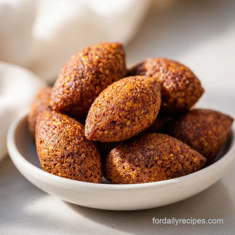 A single kibbeh slice, artfully arranged, showcases its golden crust and savory filling. Garnished with a sprig of fresh m...